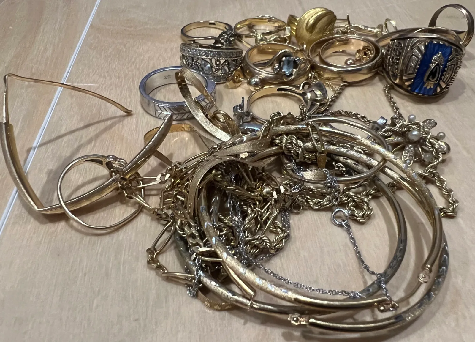 tangled pile of gold and silver rings bracelets and necklaces